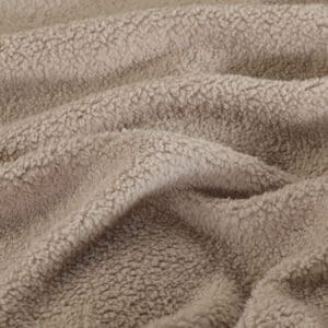 Close-up van beige teddy stoftextuur